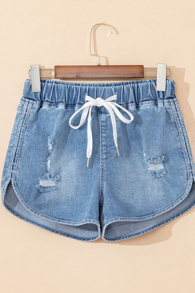 Drawstring high-waist distressed denim shorts with pockets.