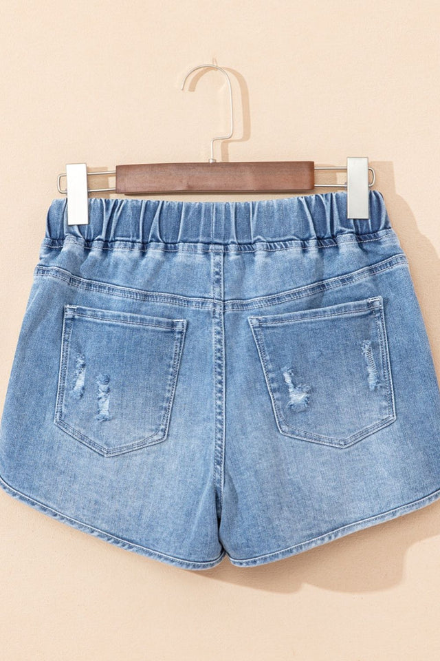 Drawstring high-waist distressed denim shorts with pockets.
