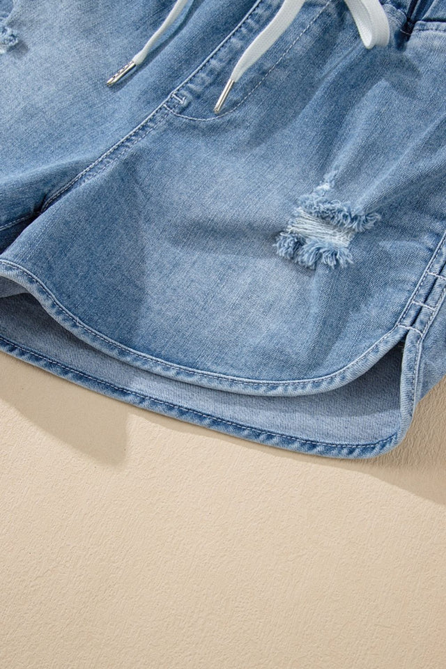Drawstring high-waist distressed denim shorts with pockets.