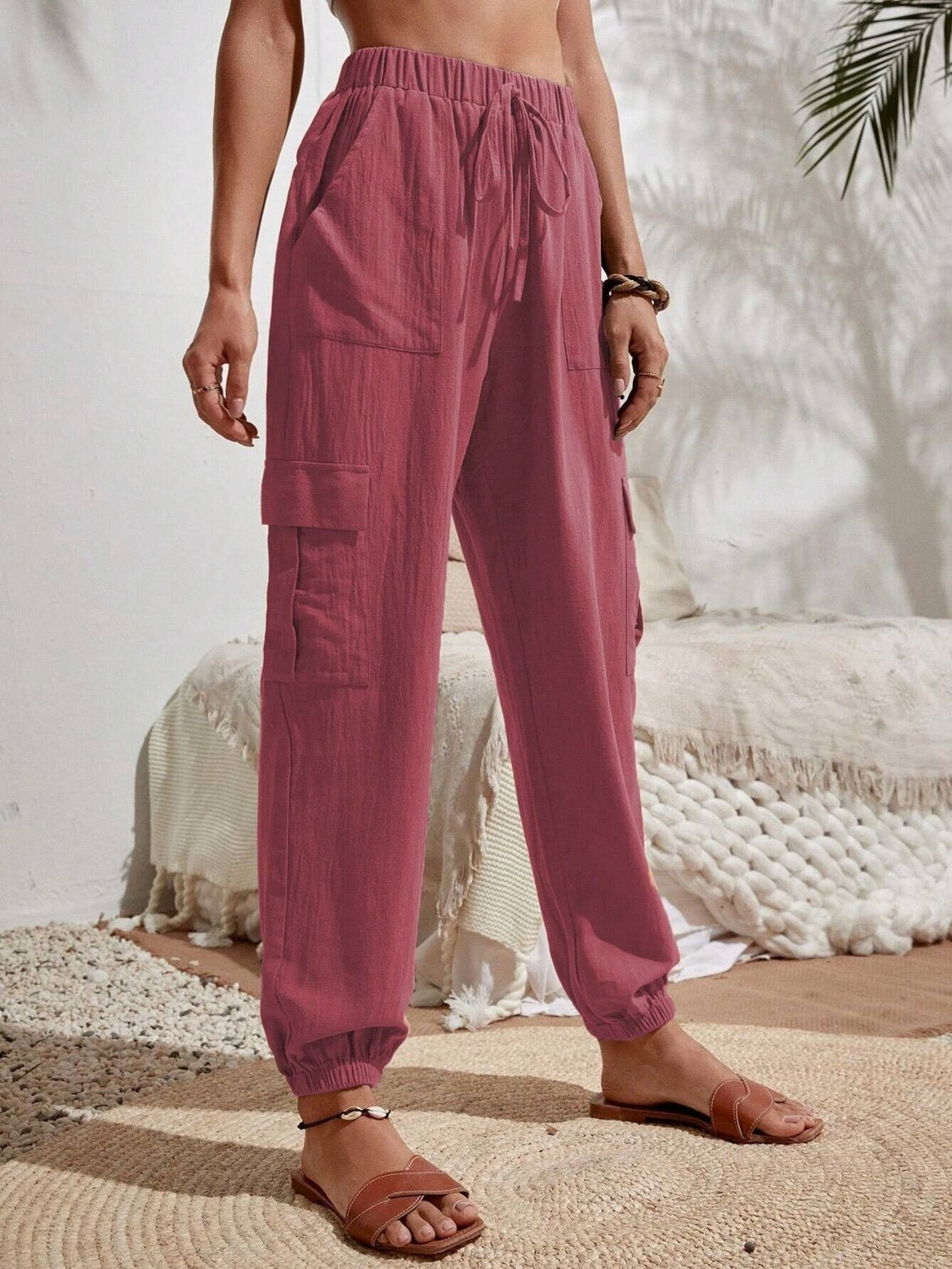 Drawstring joggers with cargo pockets, opaque.