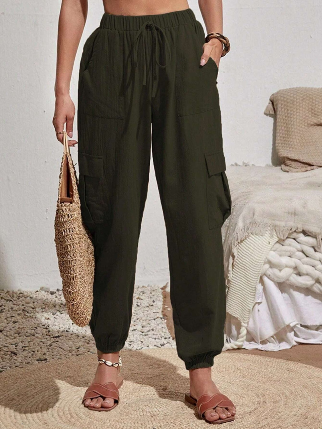 Drawstring joggers with cargo pockets, opaque.