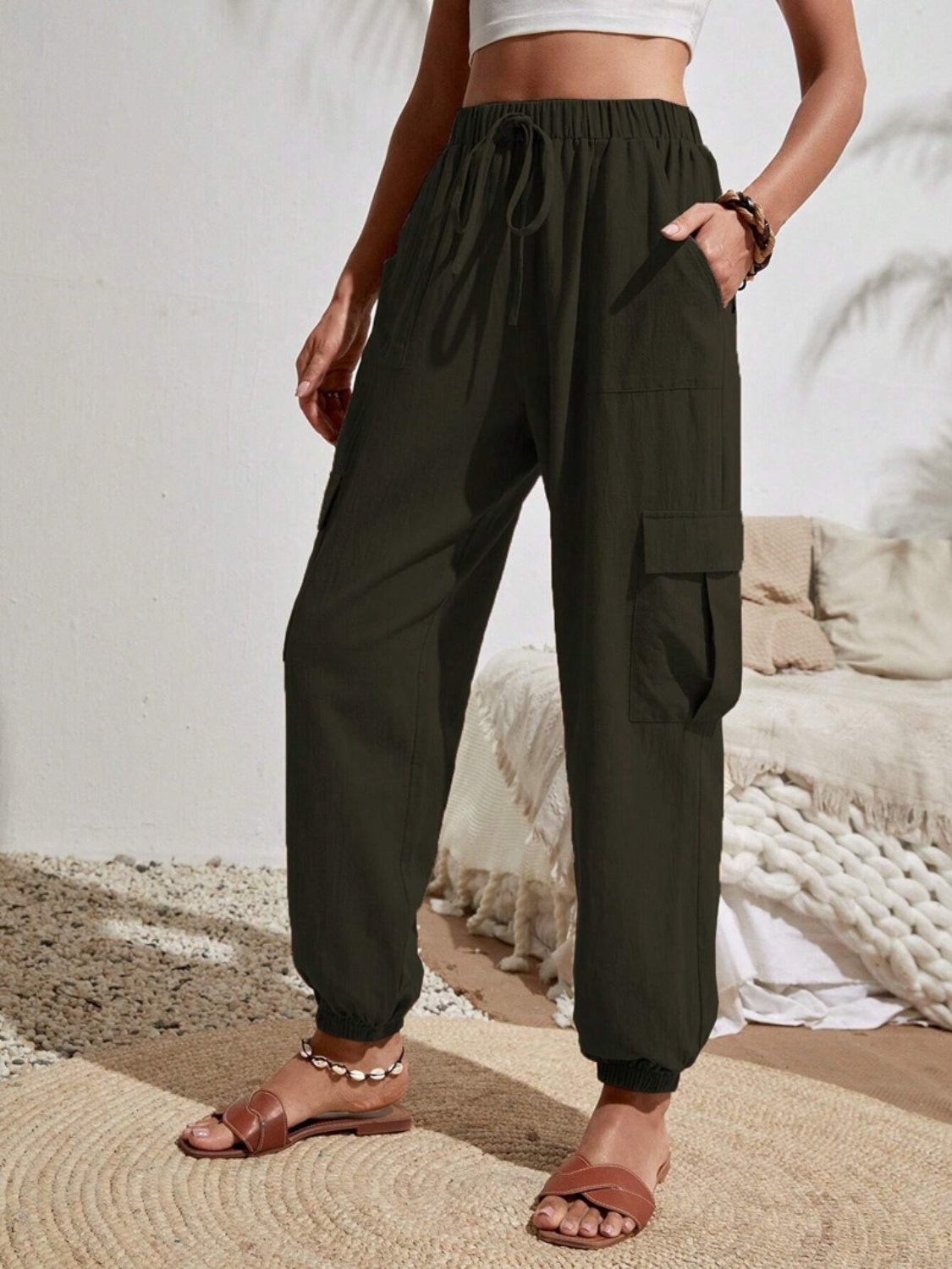 Drawstring joggers with cargo pockets, opaque.