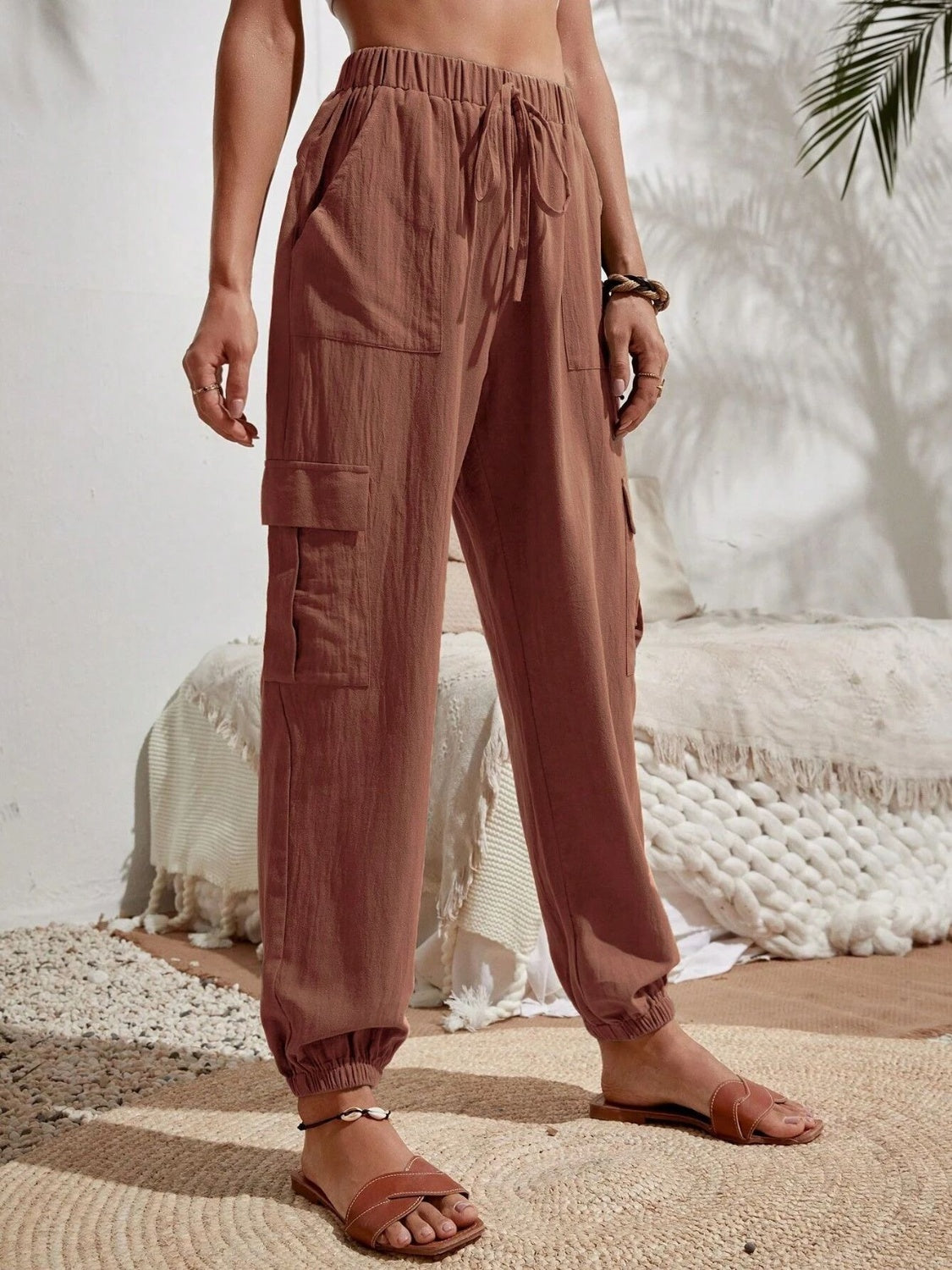 Drawstring joggers with cargo pockets, opaque.