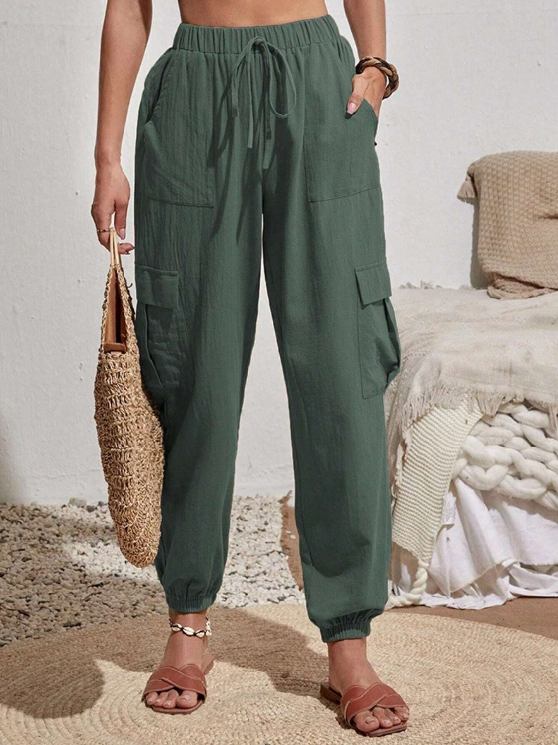 Drawstring joggers with cargo pockets, opaque.