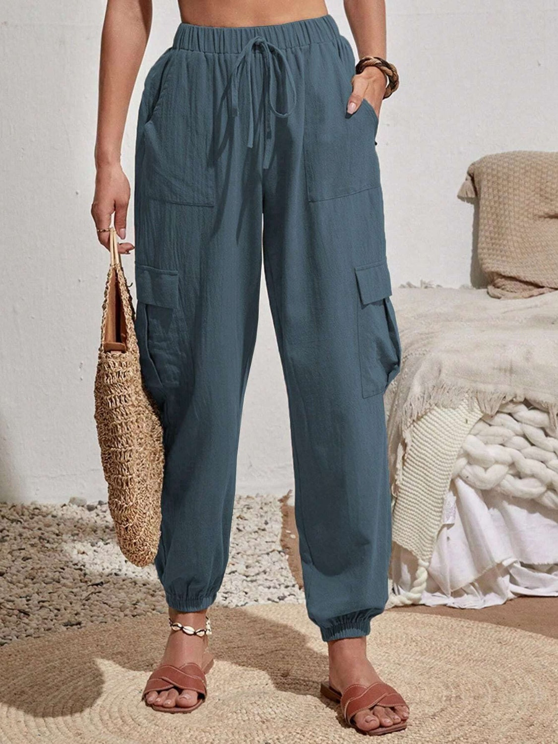 Drawstring joggers with cargo pockets, opaque.