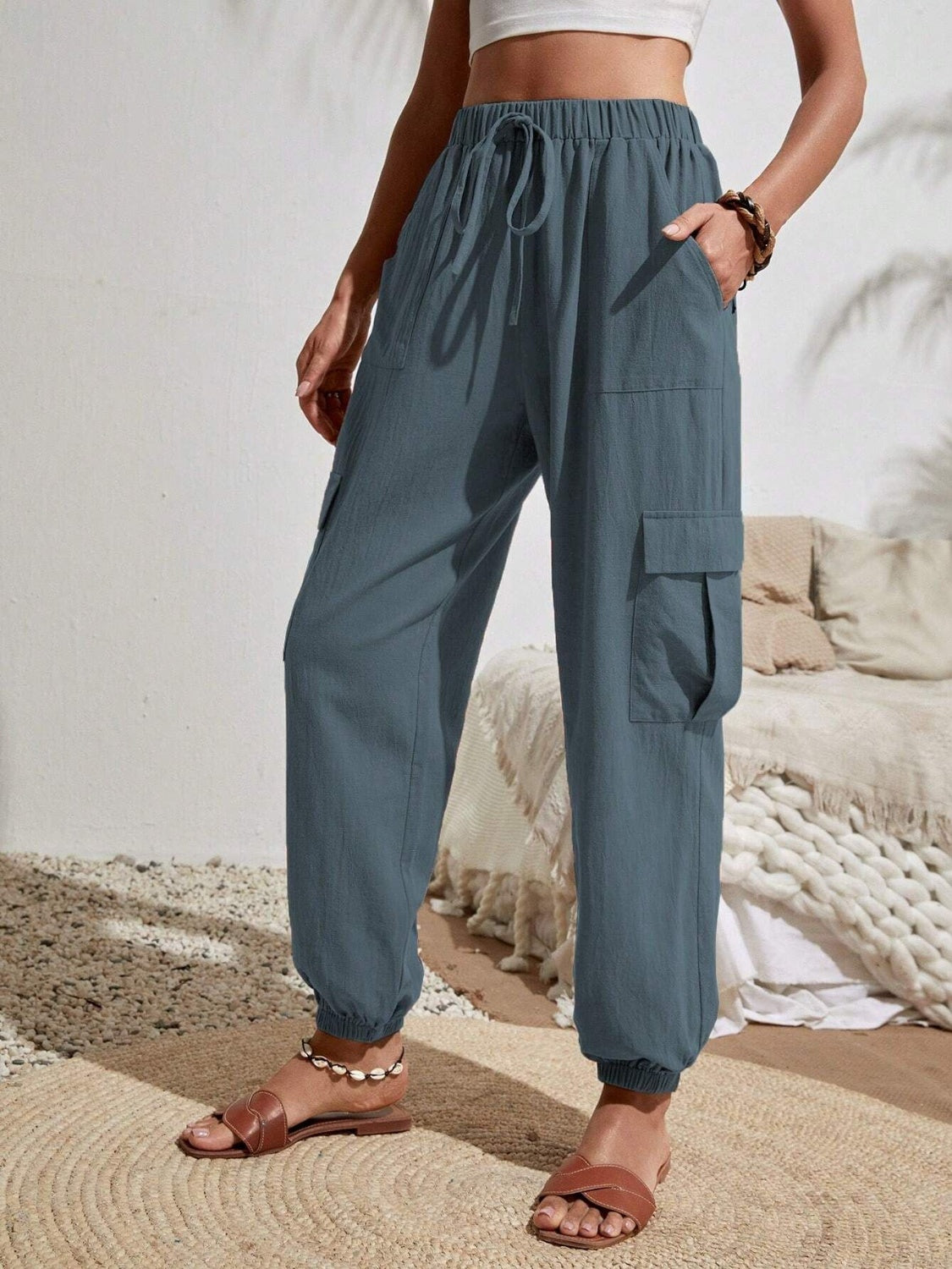 Drawstring joggers with cargo pockets, opaque.