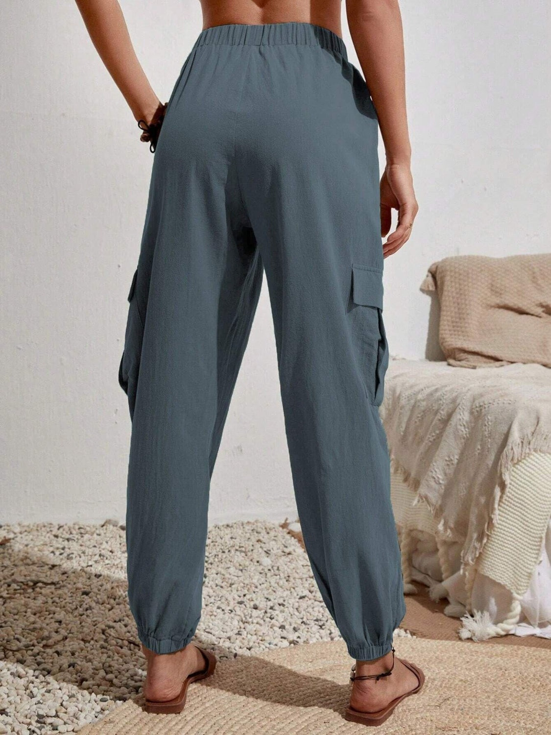 Drawstring joggers with cargo pockets, opaque.