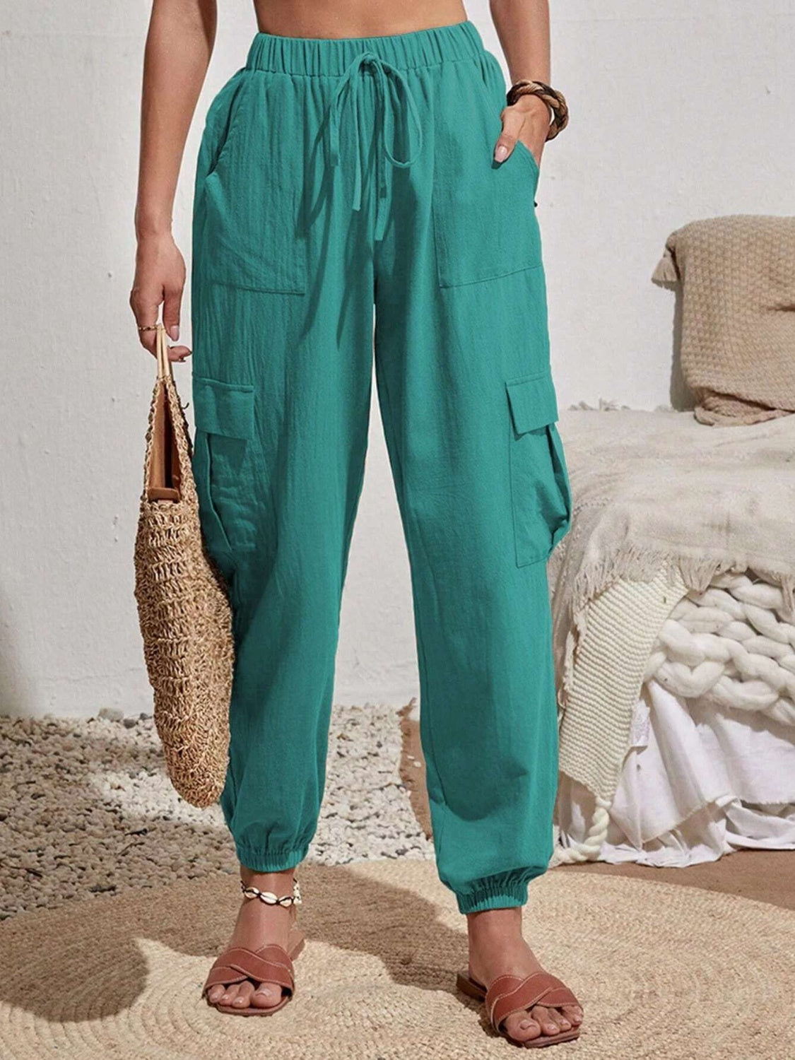 Drawstring joggers with cargo pockets, opaque.