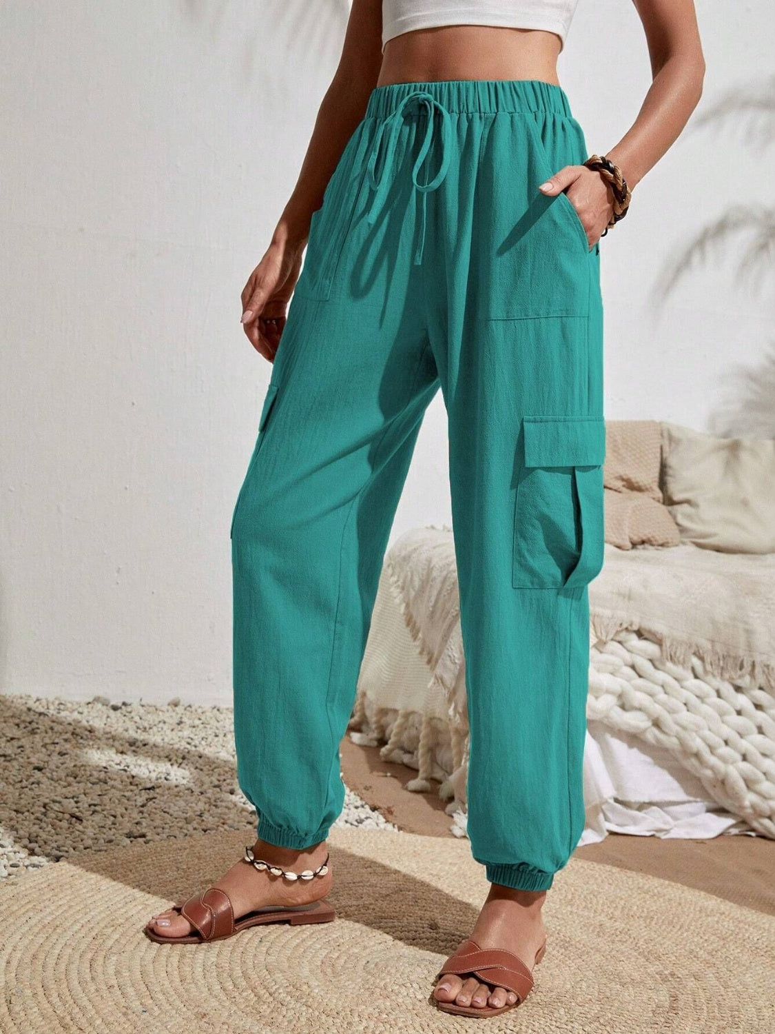 Drawstring joggers with cargo pockets, opaque.