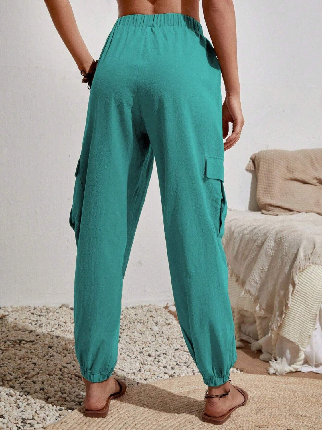 Drawstring joggers with cargo pockets, opaque.
