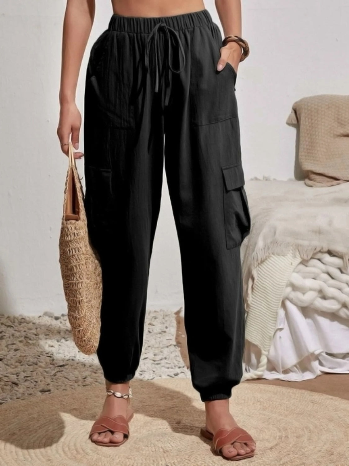 Drawstring joggers with cargo pockets, opaque.