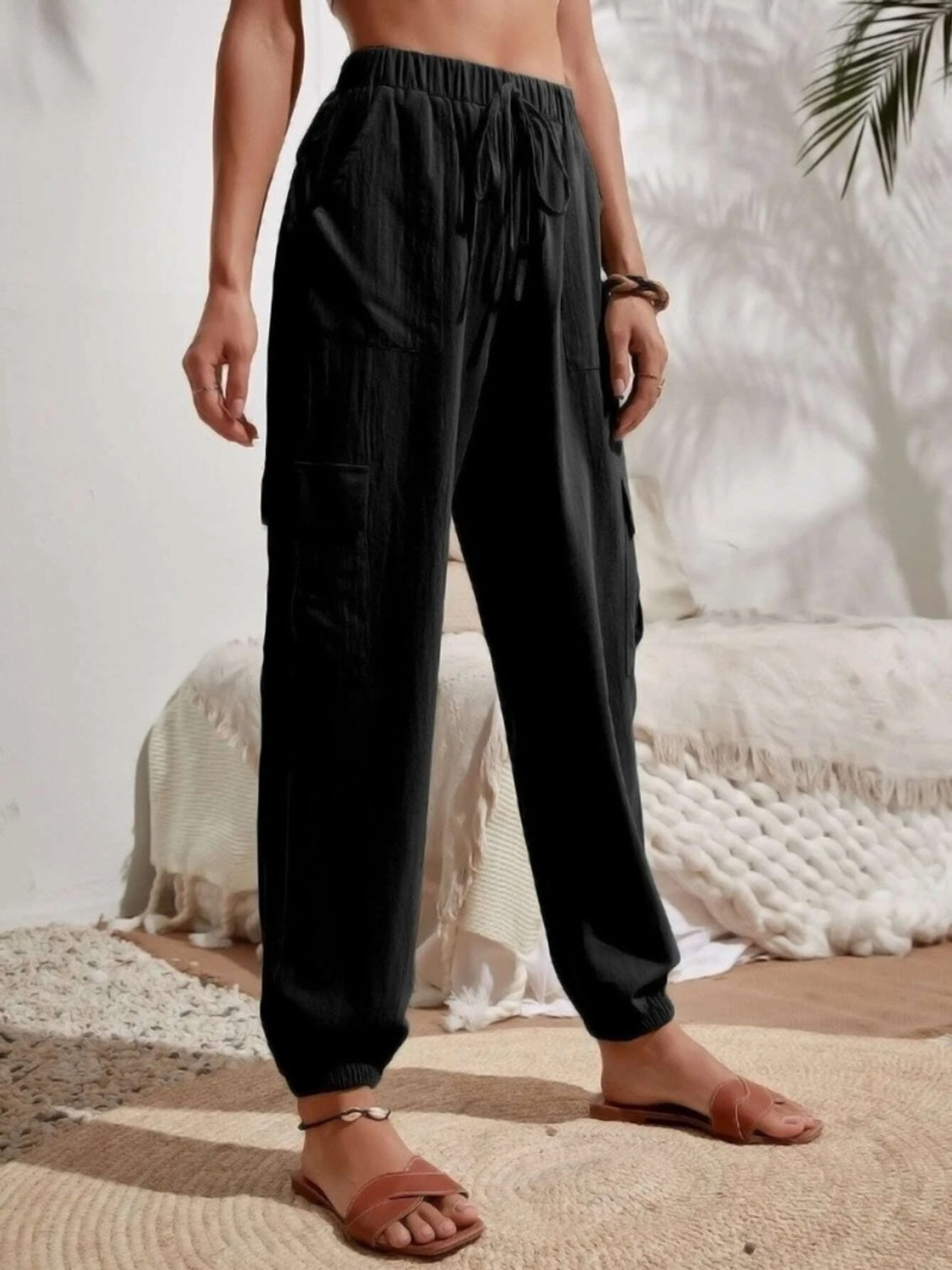 Drawstring joggers with cargo pockets, opaque.