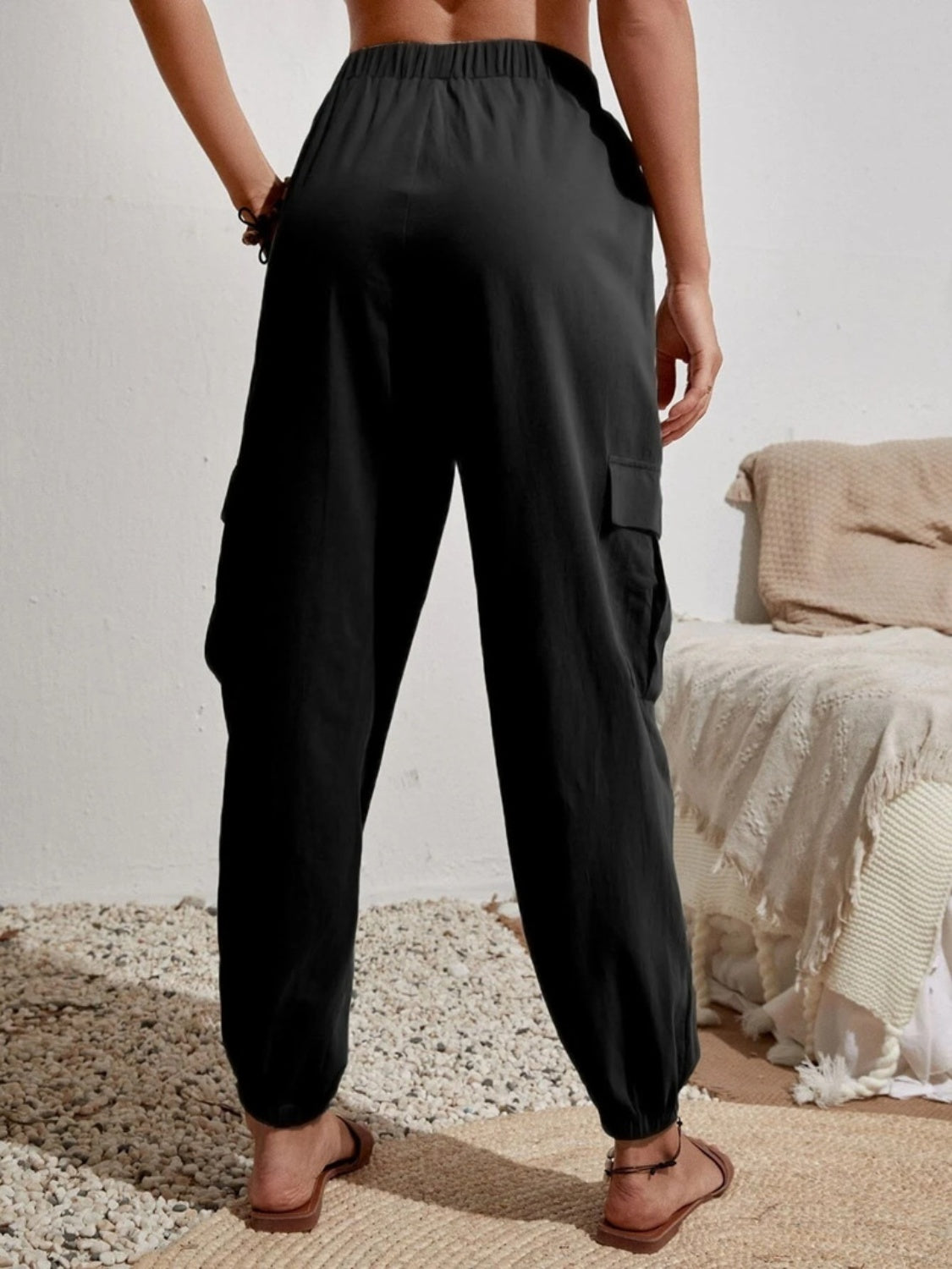 Drawstring joggers with cargo pockets, opaque.
