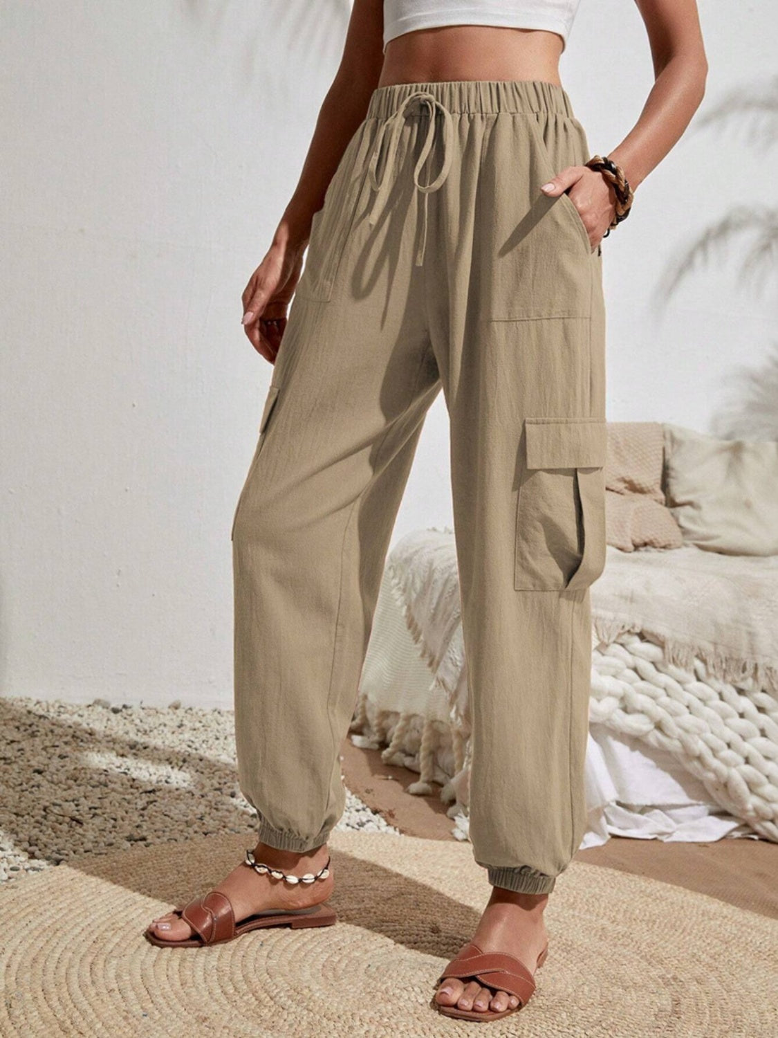 Drawstring joggers with cargo pockets, opaque.