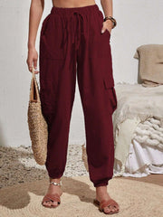 Drawstring joggers with cargo pockets, opaque.