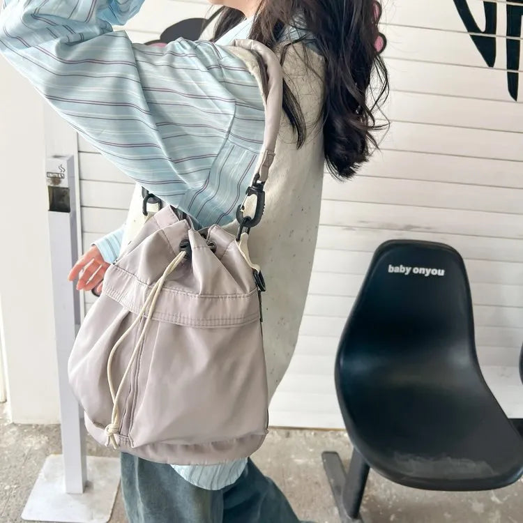 Medium nylon drawstring bucket bag.