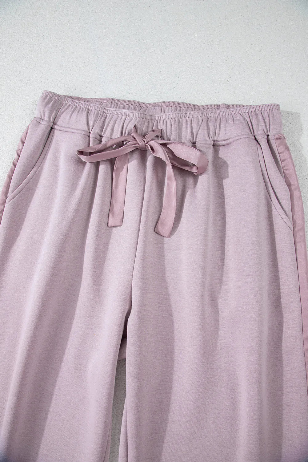 Drawstring pants with pockets, opaque.