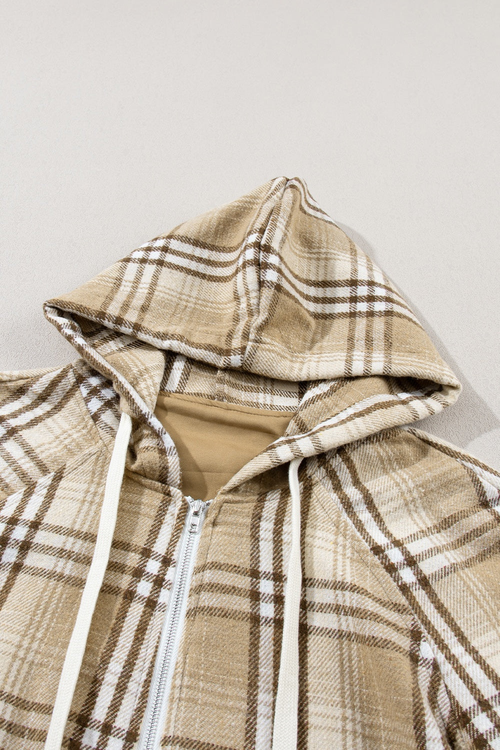 Drawstring plaid half zip raglan sleeve hoodie with pockets.