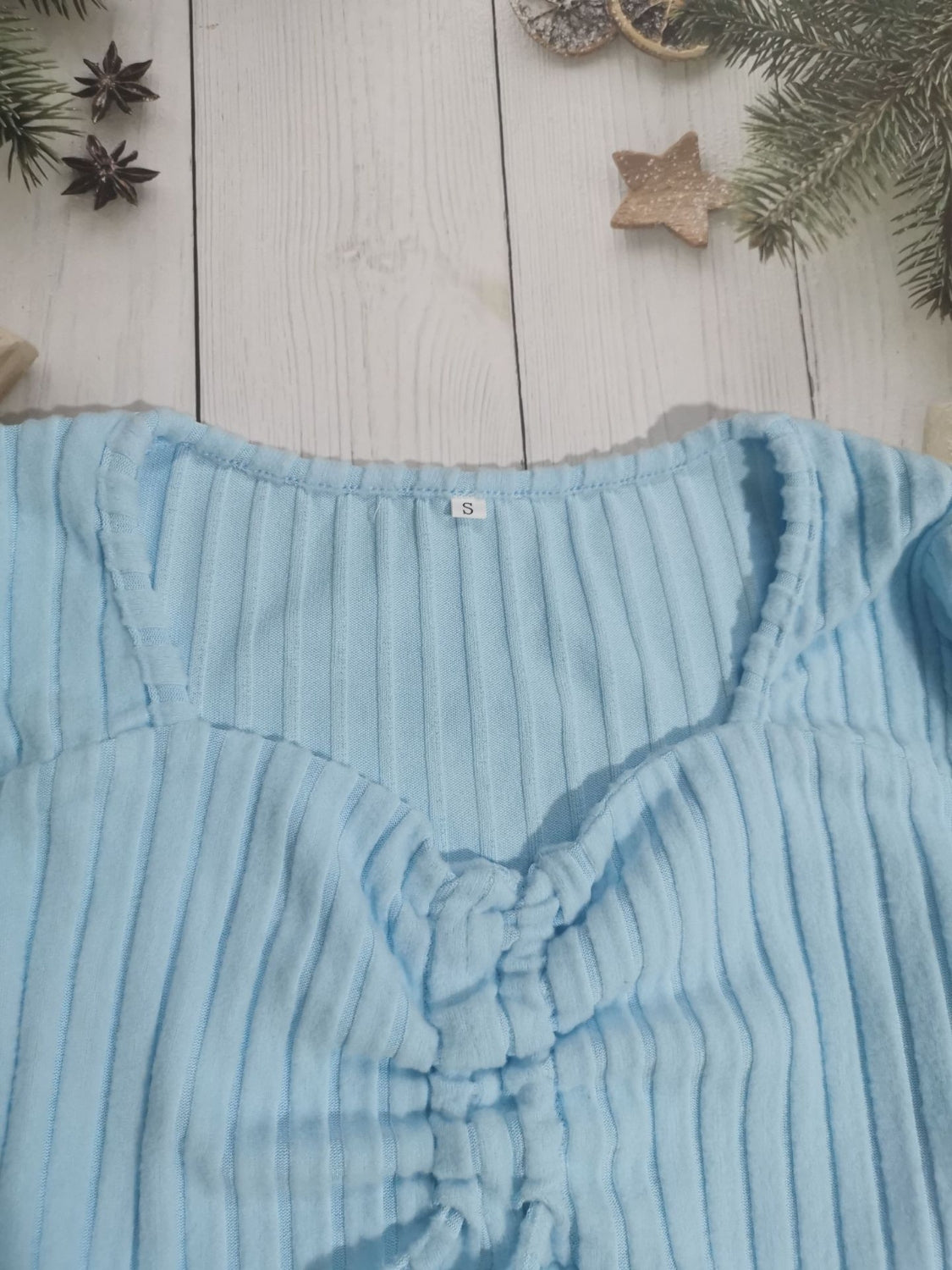 Drawstring ruched long sleeve ribbed top.