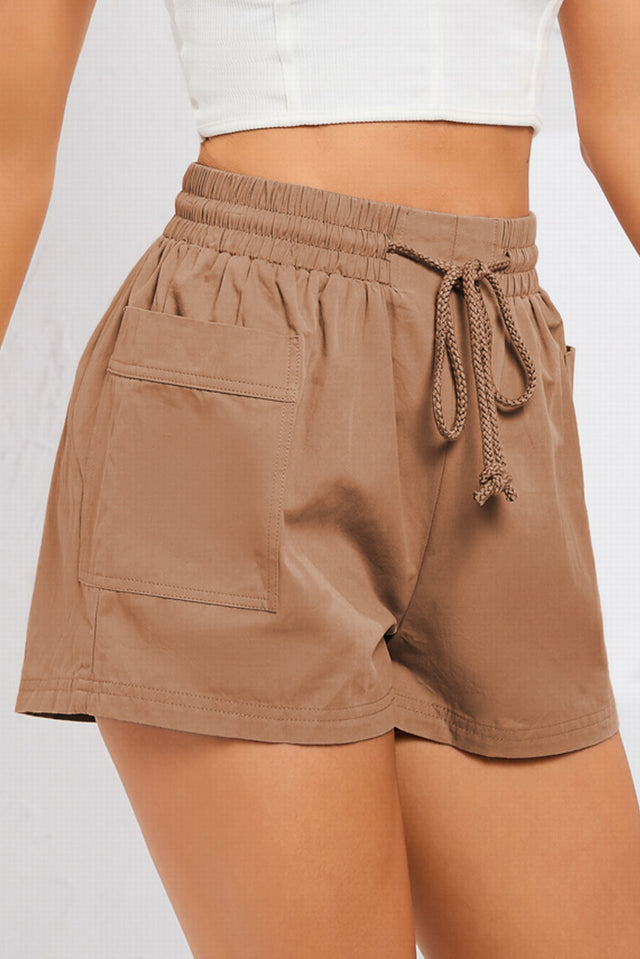Solid drawstring smocked waist pocketed shorts.