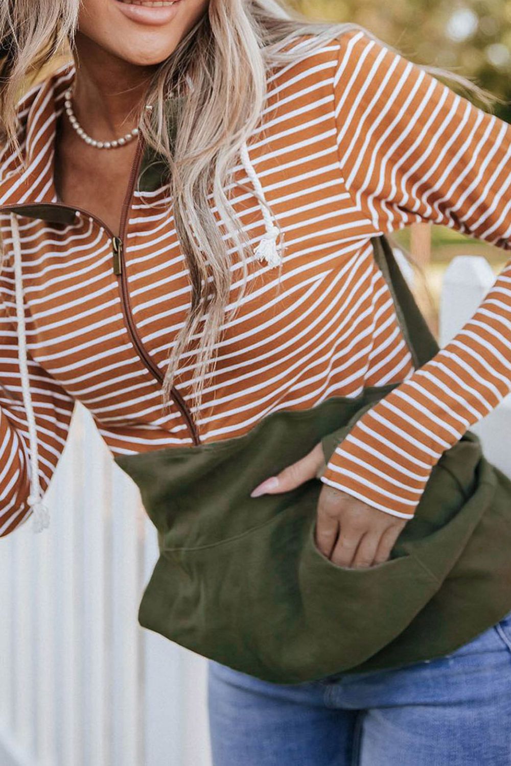 Drawstring stripe half zip long sleeve hoodie with pockets.