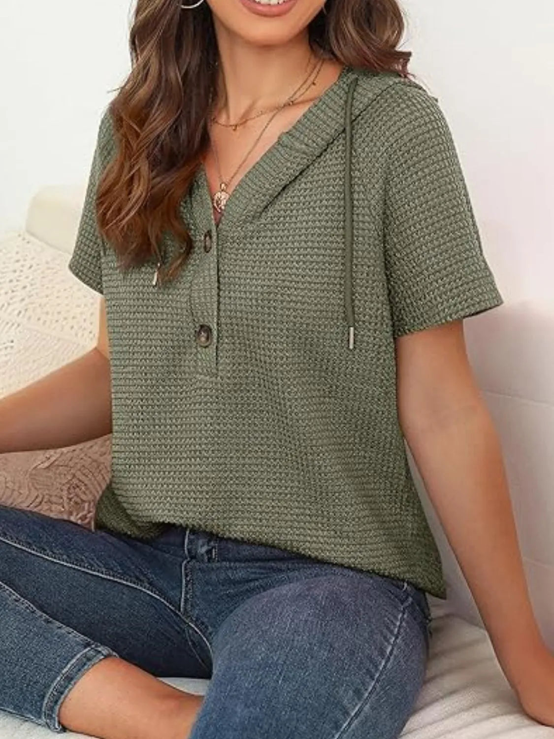 Drawstring waffle-knit short sleeve hooded top with buttons.