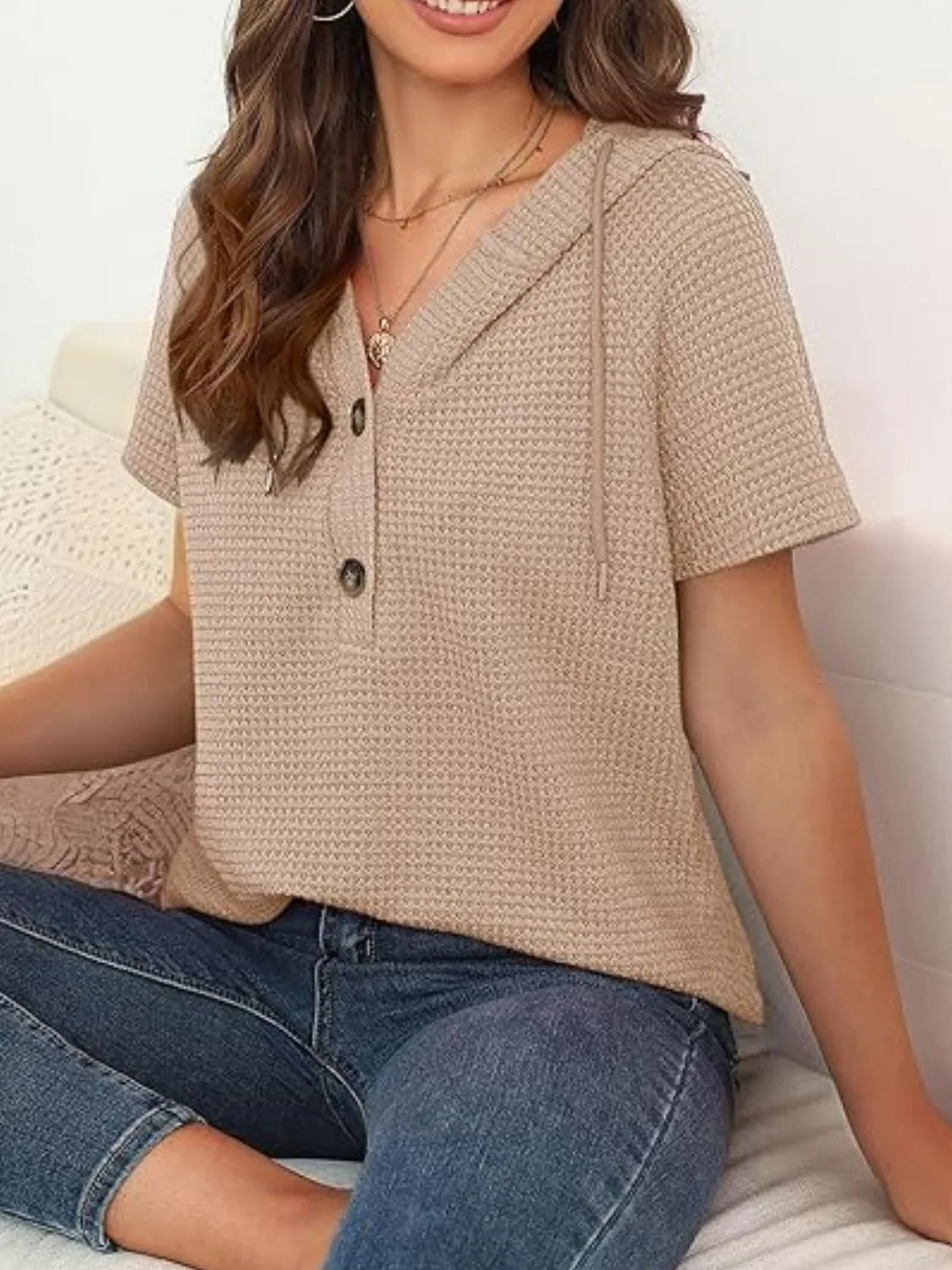 Drawstring waffle-knit short sleeve hooded top with buttons.