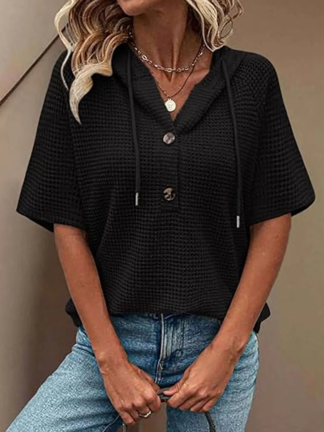 Drawstring waffle-knit short sleeve hooded top with buttons.