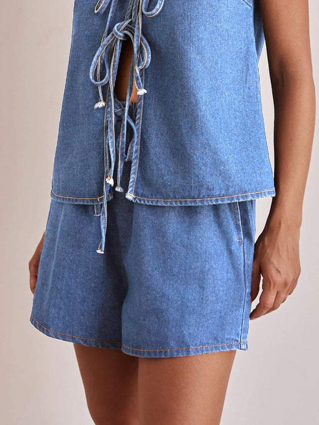 Elastic waist denim shorts with tie detail.