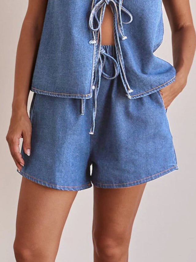 Elastic waist denim shorts with tie detail.
