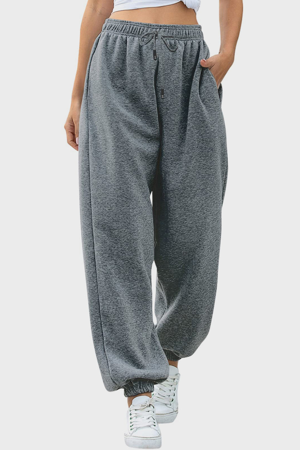 Elastic waist joggers with tie and pockets, opaque.