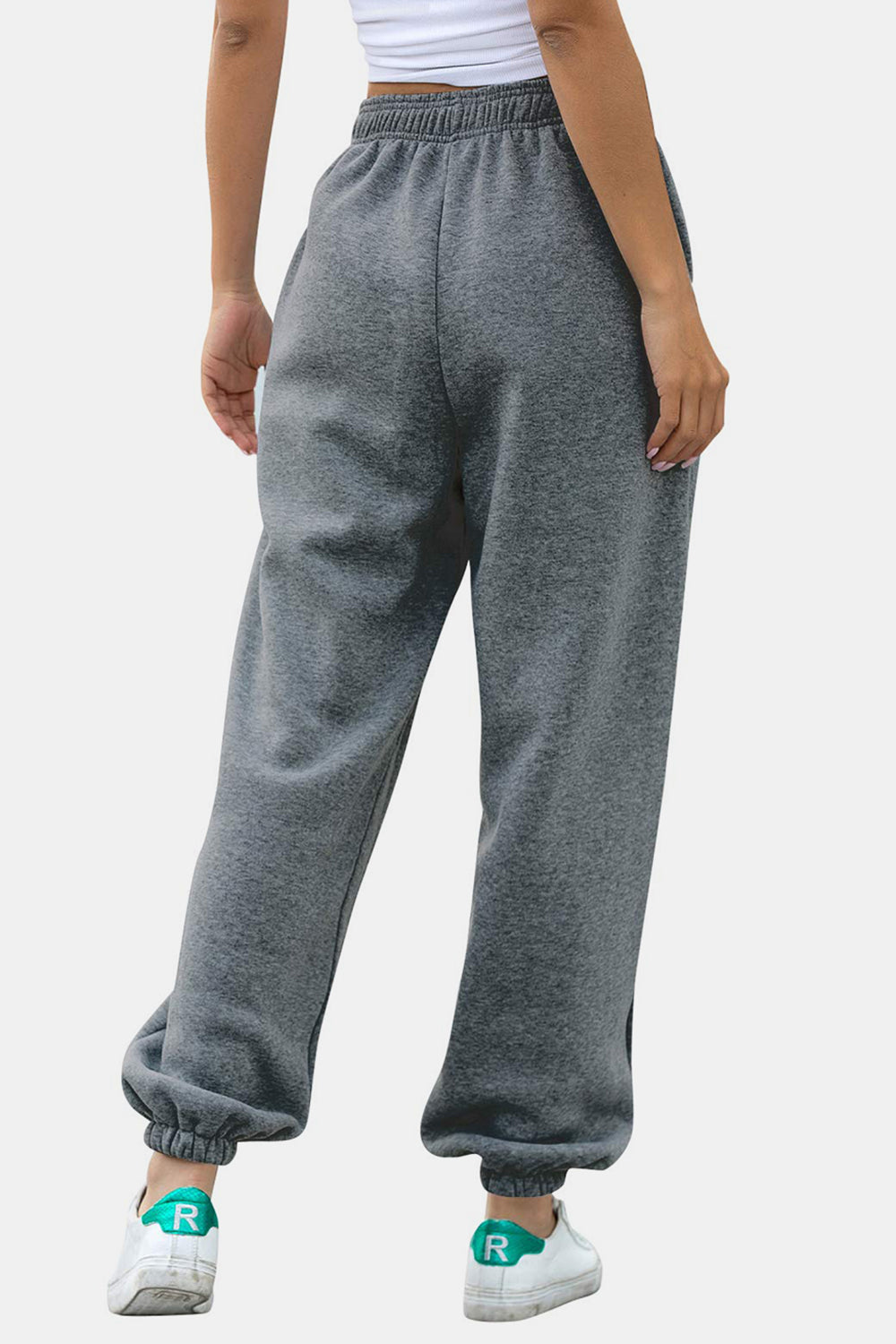 Elastic waist joggers with tie and pockets, opaque.
