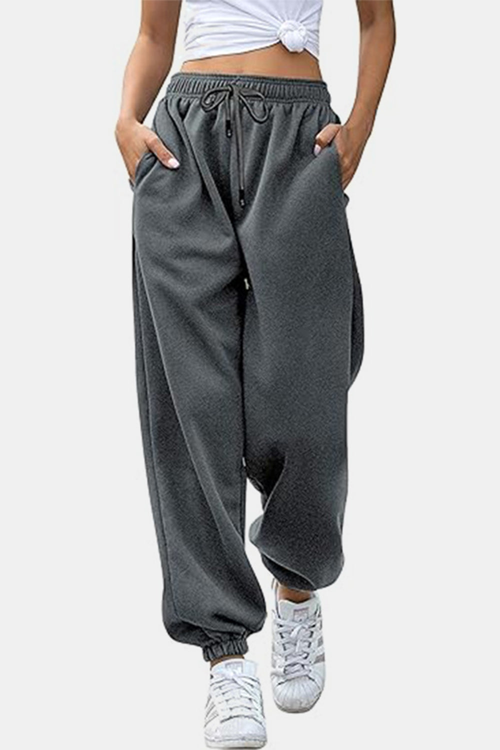 Elastic waist joggers with tie and pockets, opaque.