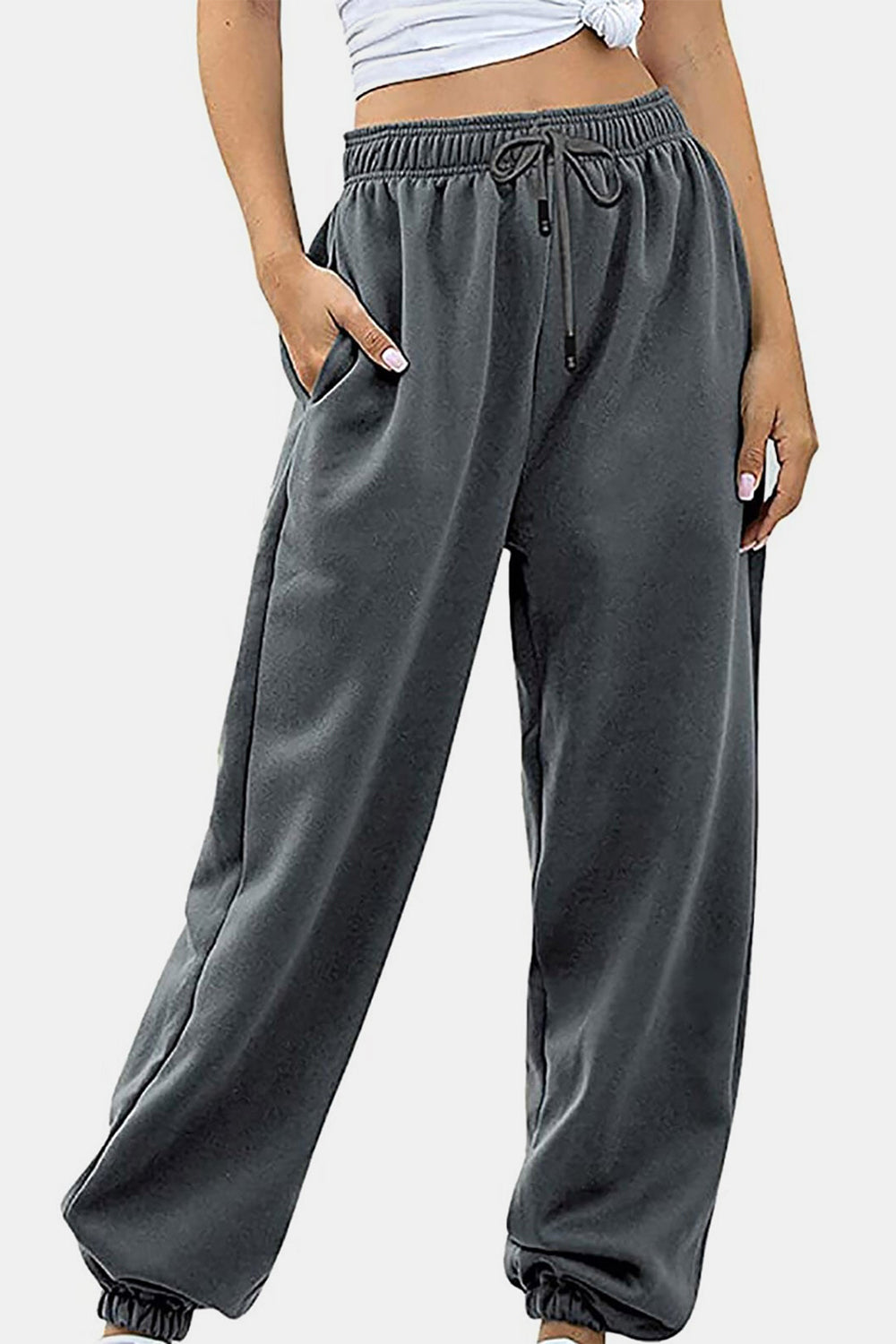 Elastic waist joggers with tie and pockets, opaque.