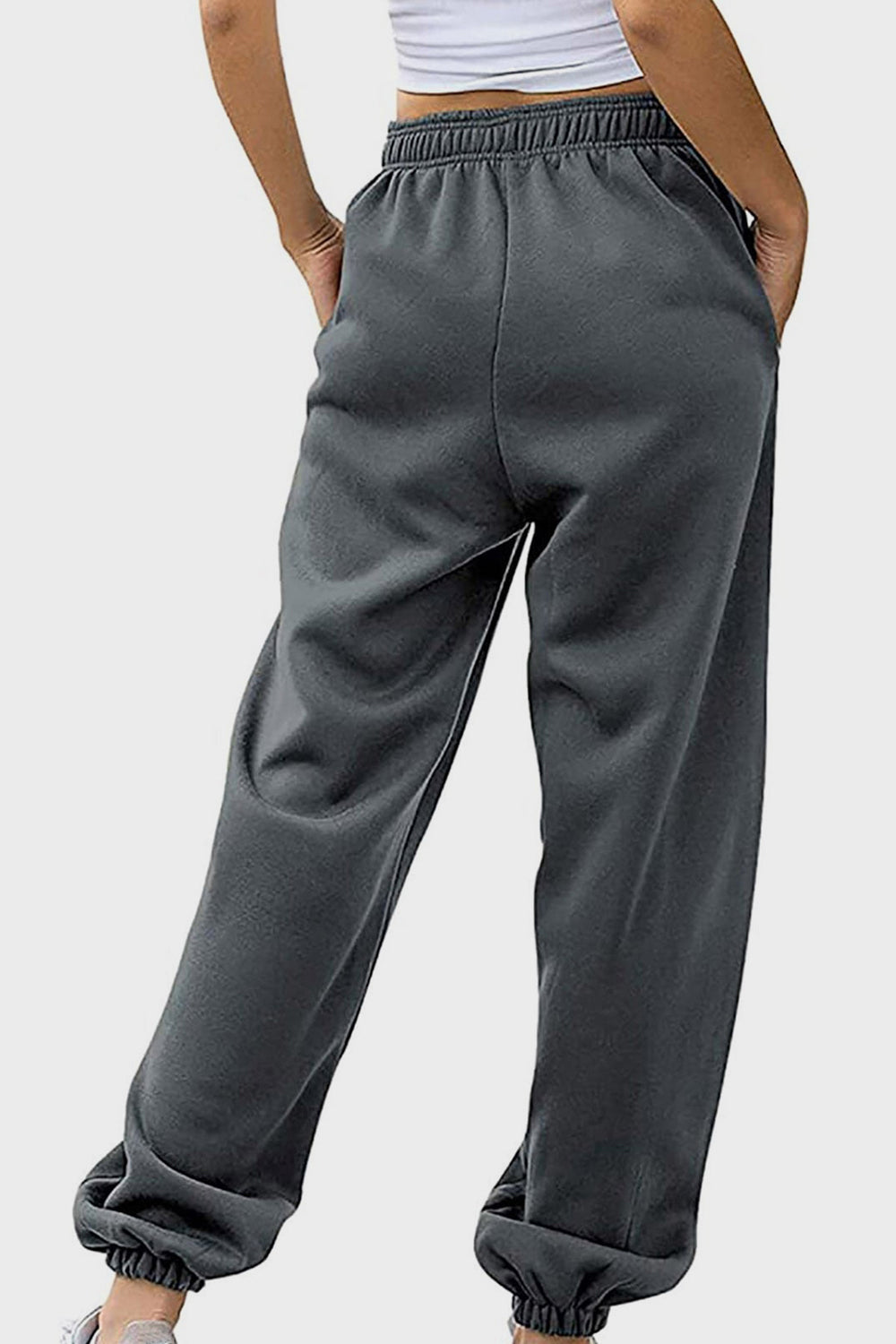 Elastic waist joggers with tie and pockets, opaque.