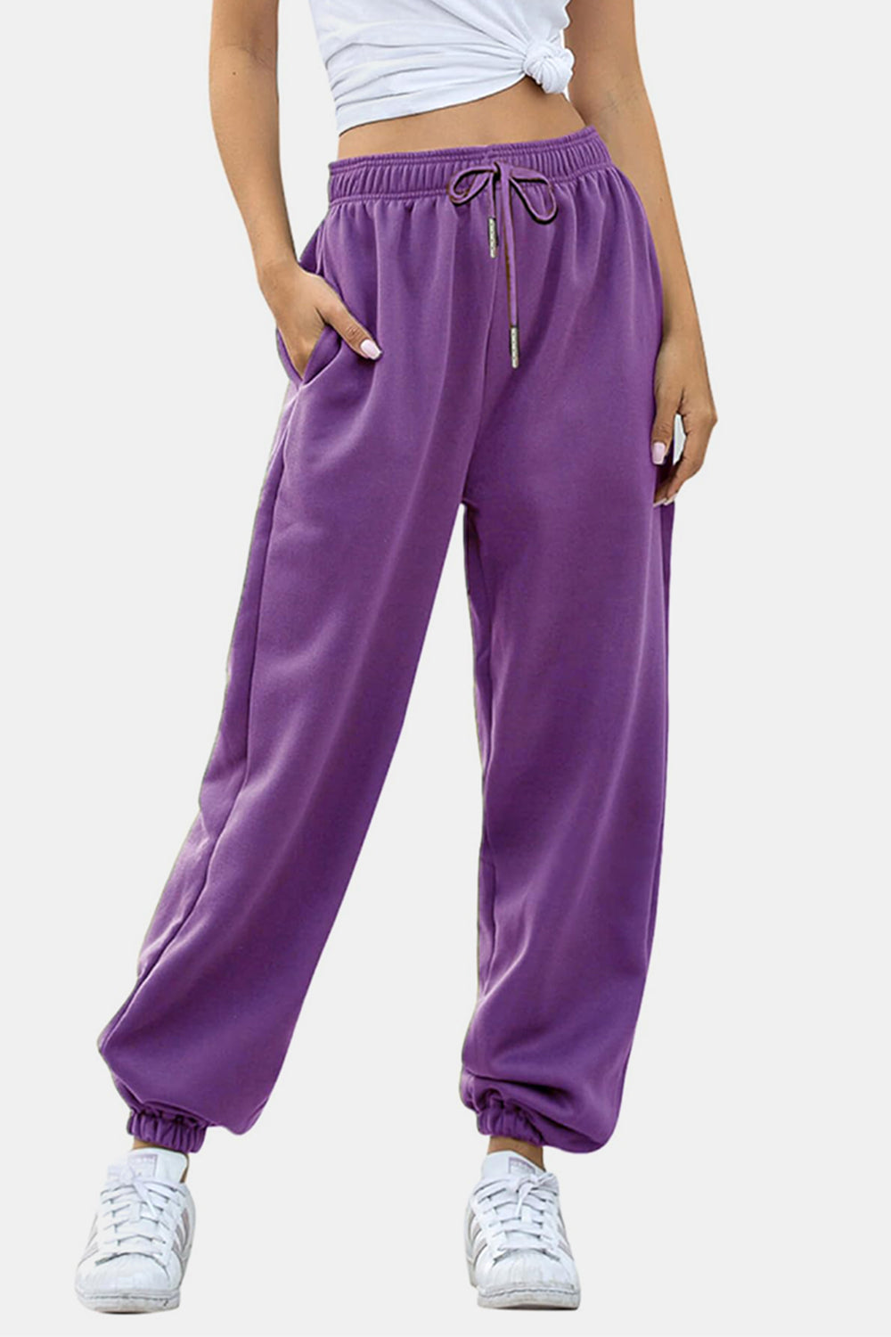 Elastic waist joggers with tie and pockets, opaque.