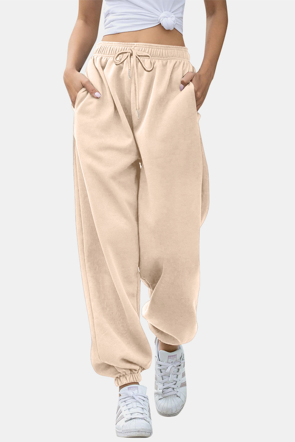 Elastic waist joggers with tie and pockets, opaque.