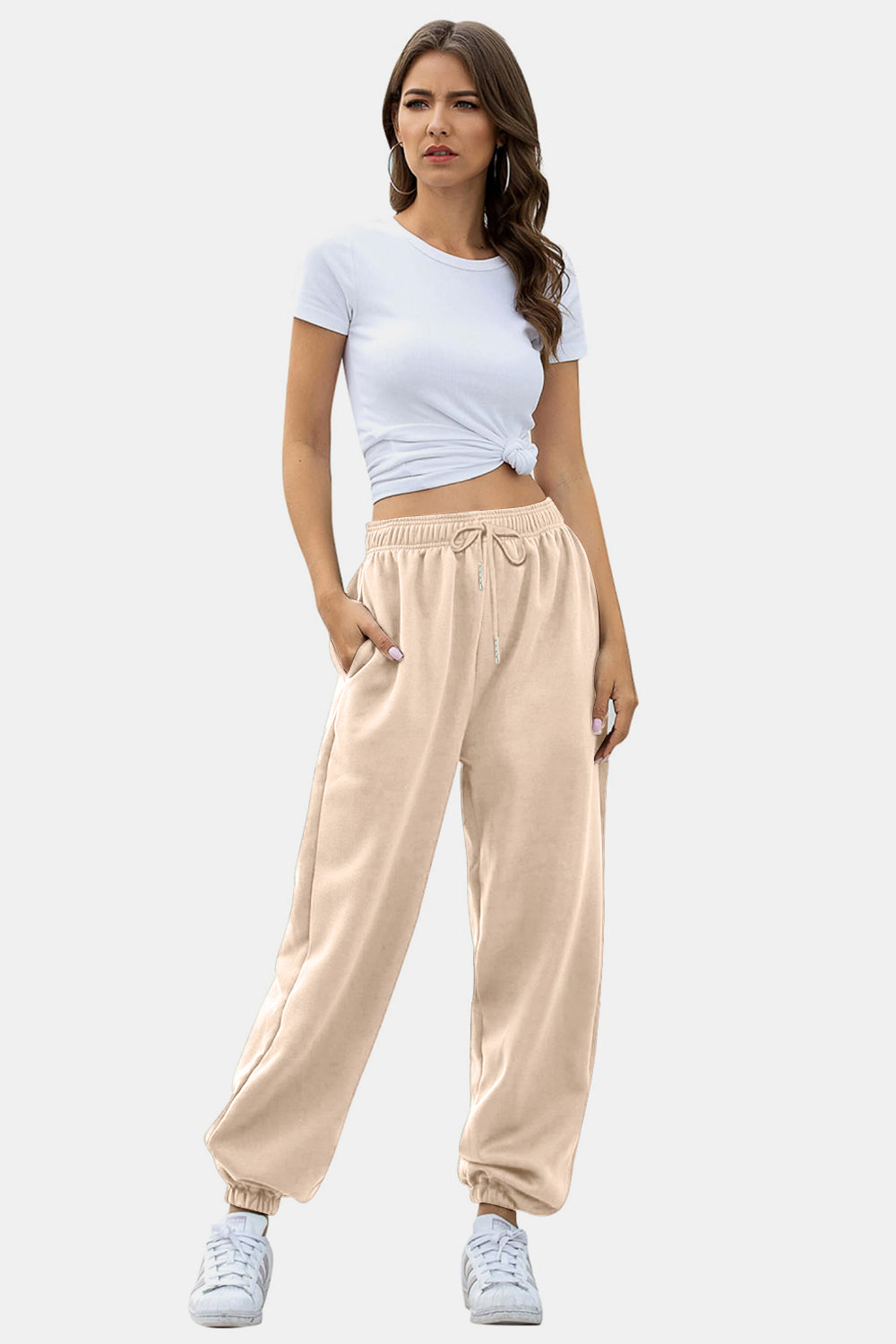 Elastic waist joggers with tie and pockets, opaque.