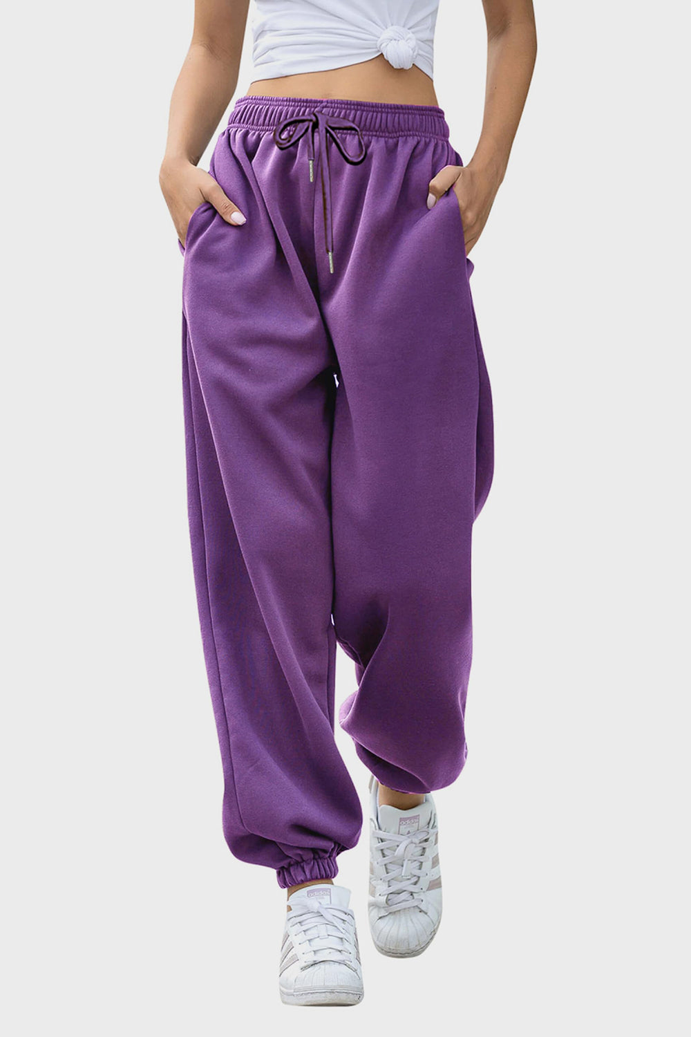 Elastic waist joggers with tie and pockets, opaque.