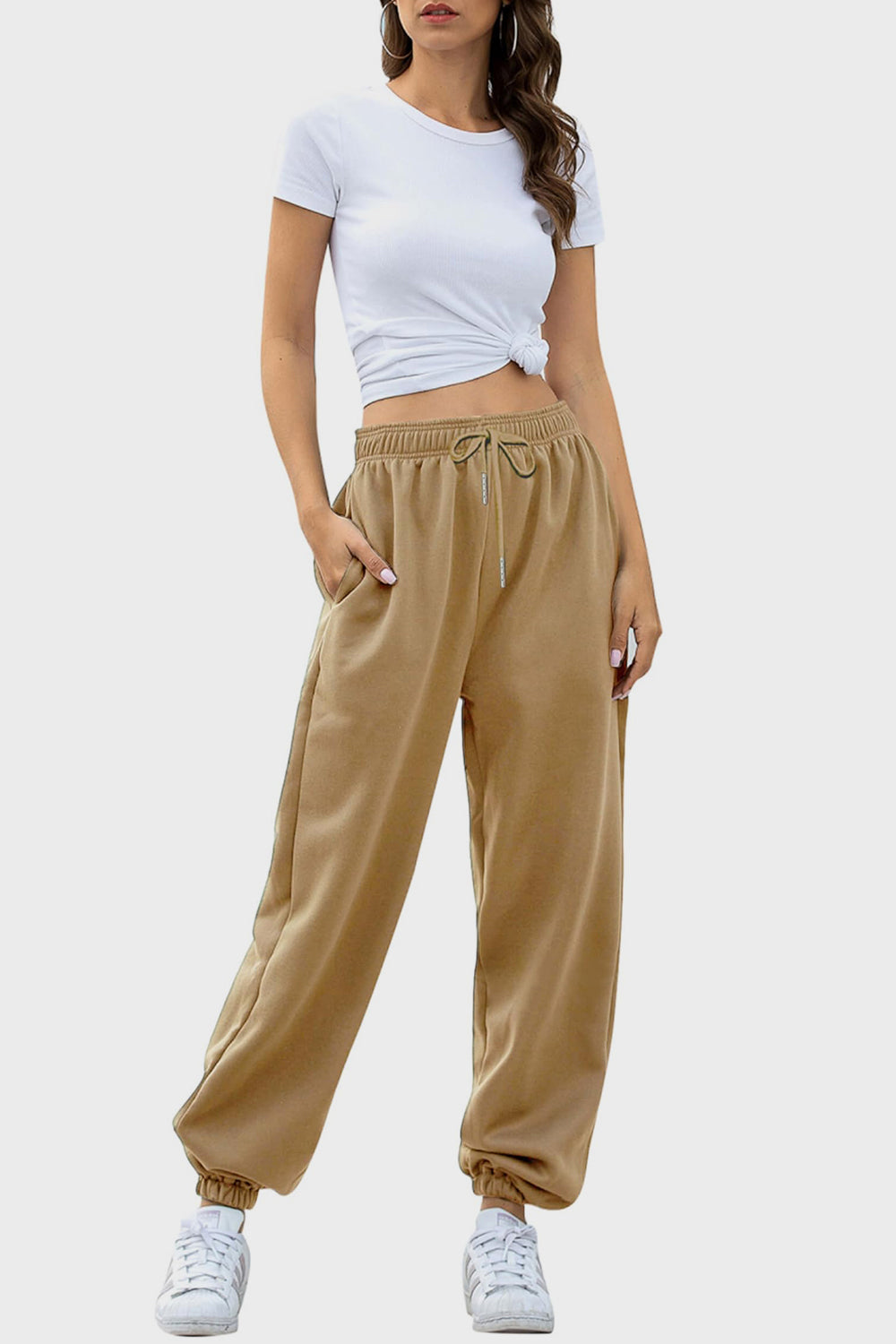 Elastic waist joggers with tie and pockets, opaque.