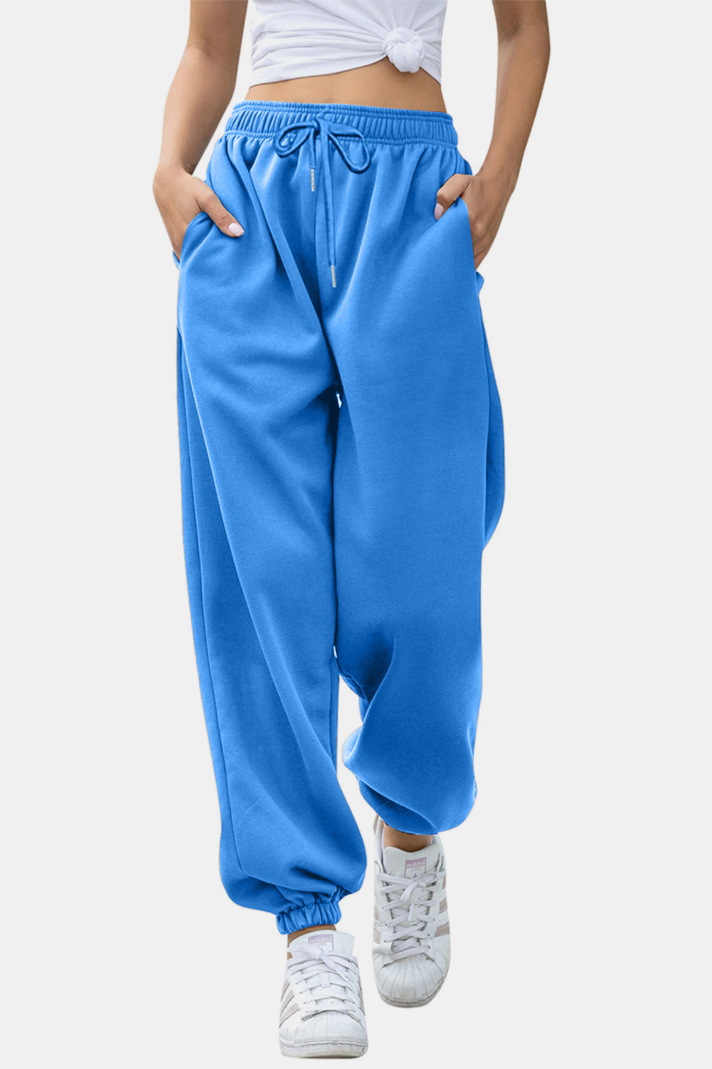 Elastic waist joggers with tie and pockets, opaque.