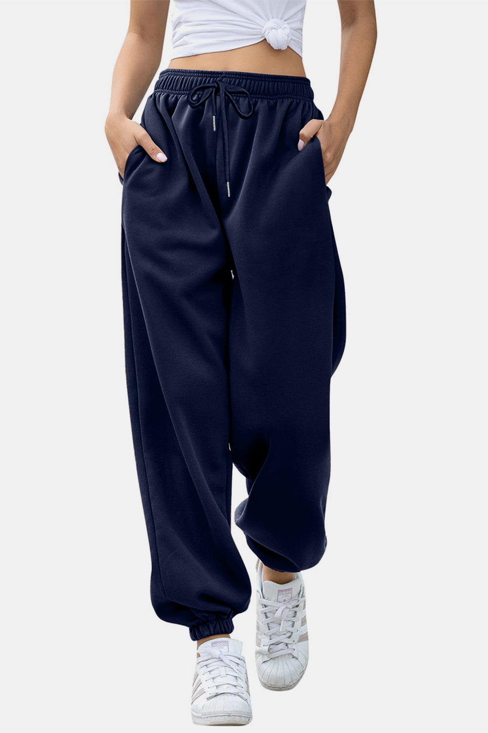 Elastic waist joggers with tie and pockets, opaque.