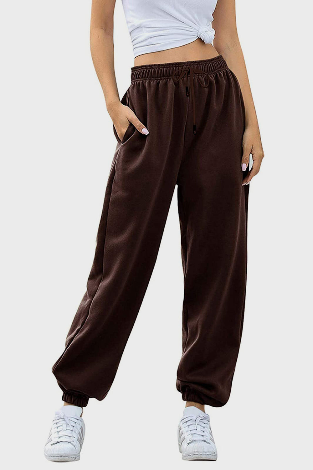 Elastic waist joggers with tie and pockets, opaque.