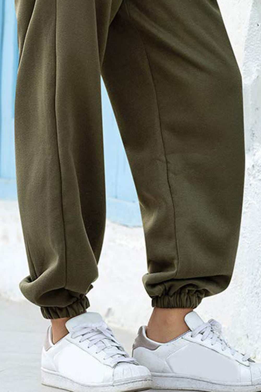 Elastic waist joggers with tie and pockets, opaque.