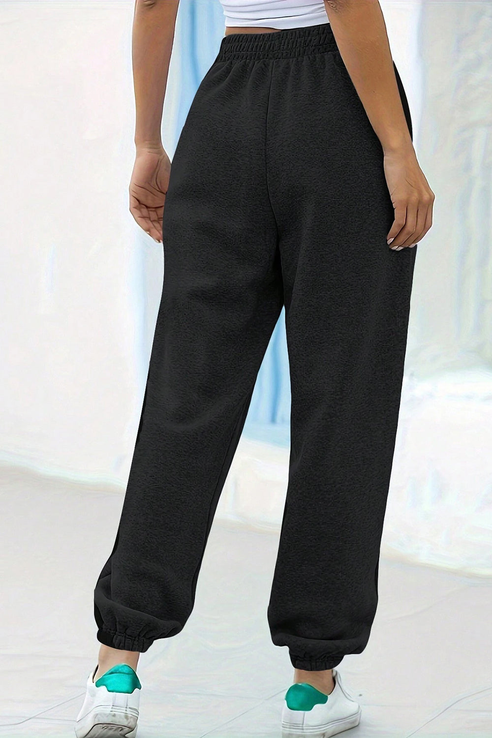 Elastic waist joggers with tie and pockets, opaque.