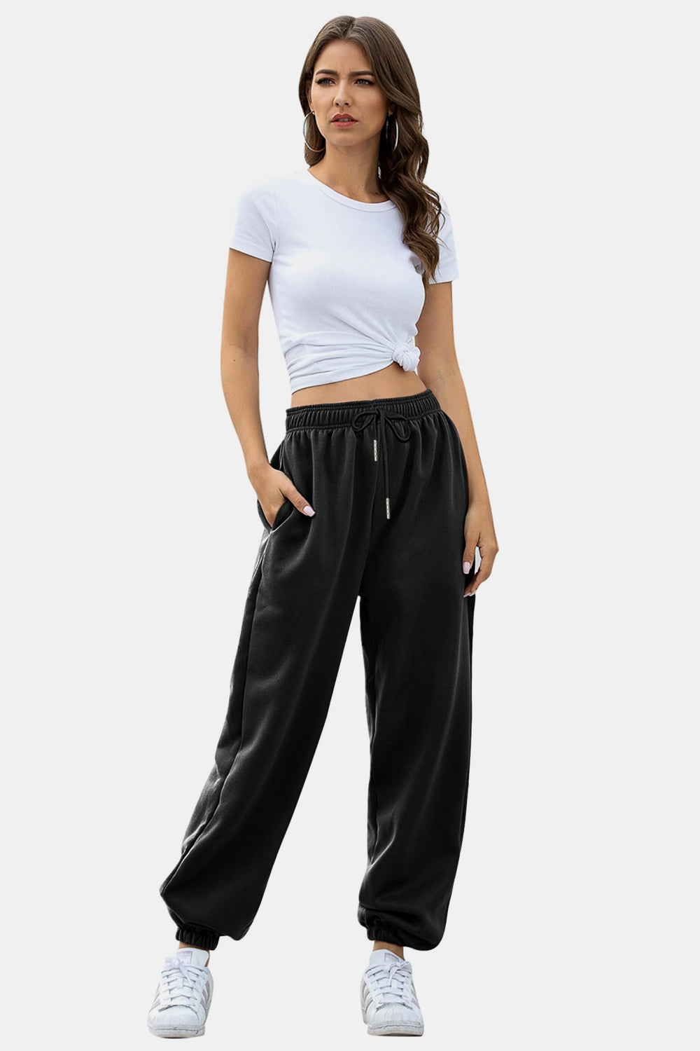 Elastic waist joggers with tie and pockets, opaque.