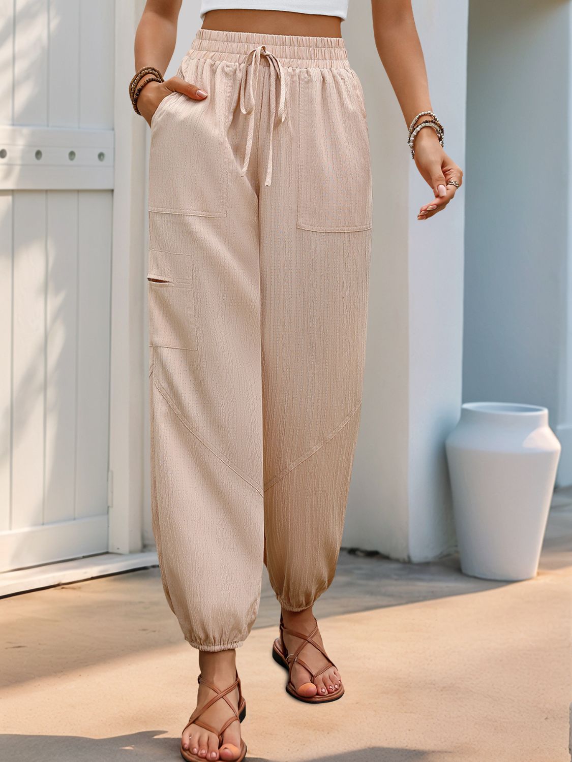 Elastic waist joggers with drawstring and pockets, opaque.