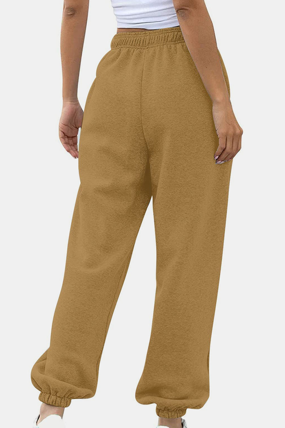 Elastic waist joggers with tie and pockets, opaque.