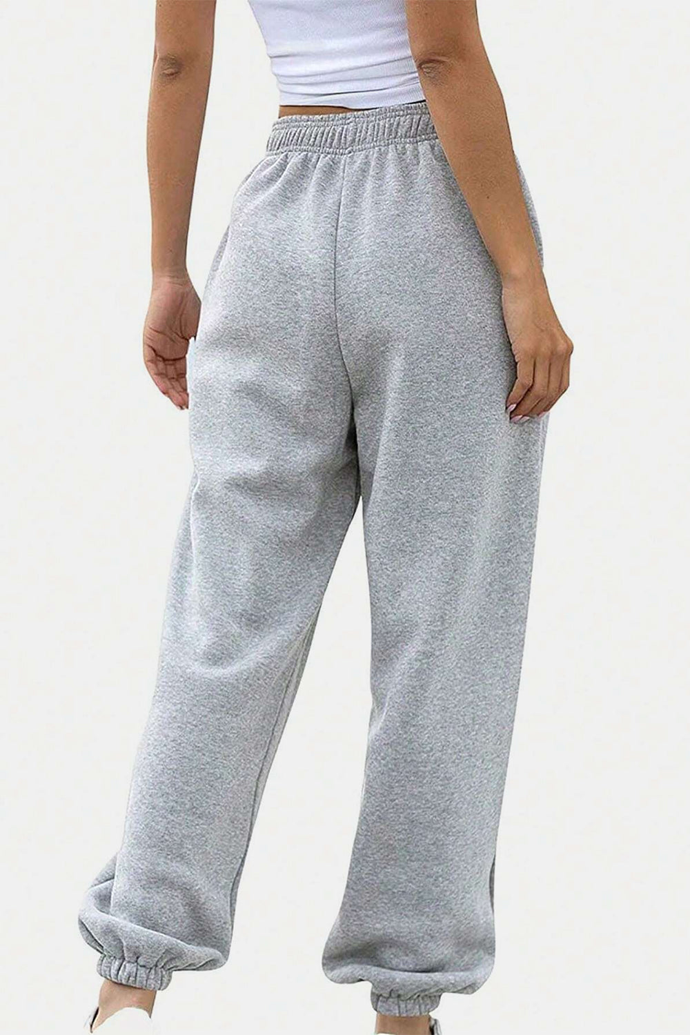 Elastic waist joggers with tie and pockets, opaque.