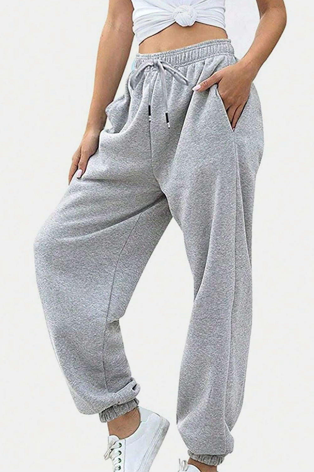 Elastic waist joggers with tie and pockets, opaque.